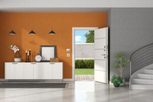 Entrance hallway with open door, sideboard on orange wall and concrete staircase - 3d rendering